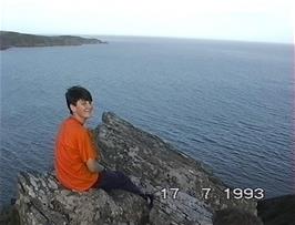 Tao admires the view from Sharp Tor, on the coast path near the hostel